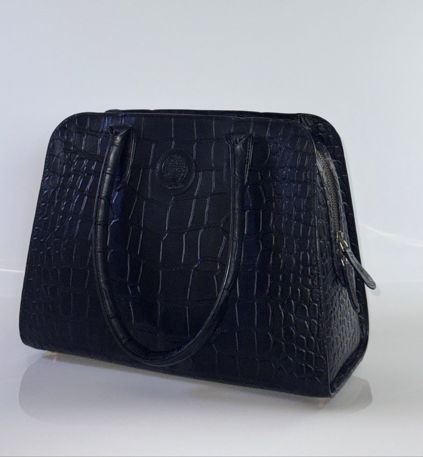 Black textured handbag on a white background